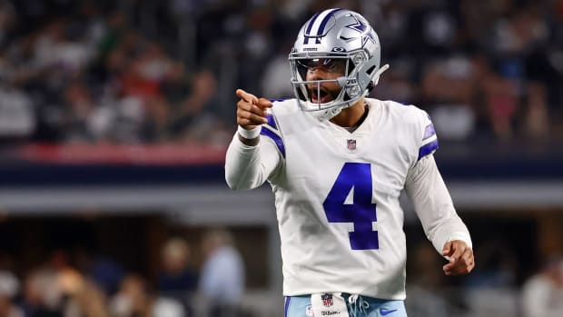 Dak Prescott points with one hand